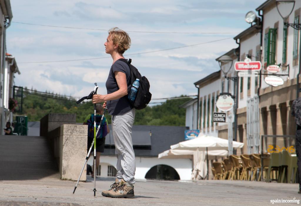 Perfect pilgrim with walking sticks, trekking shoes, small backpack