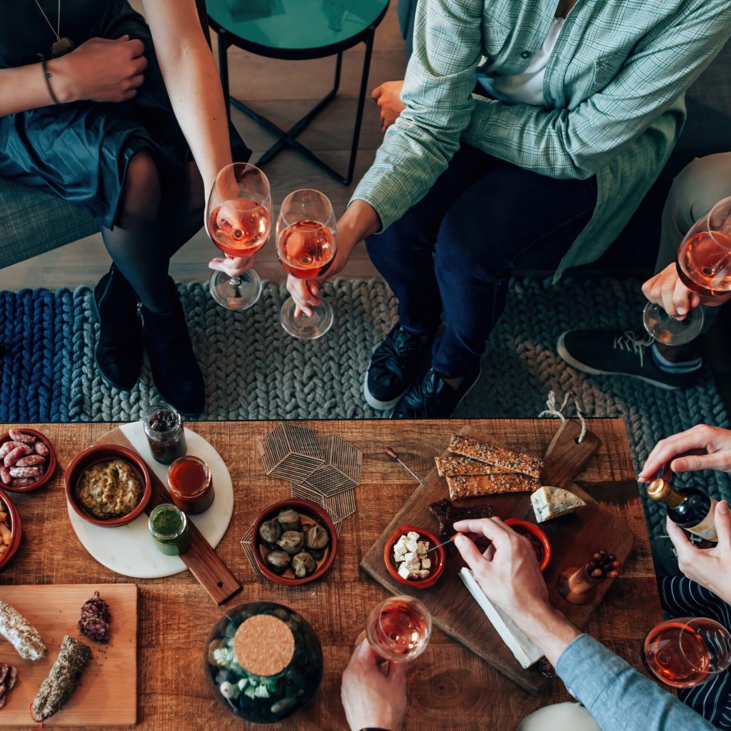 top view of table diner with tapas food - friends people eating and grabbing appetizer sitting around together