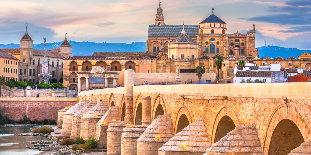 Cordoba, Spain at the Roman Bridge and Mosque-Cathedral on the Guadalquivir River.